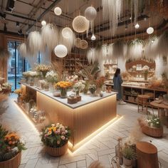 a flower shop filled with lots of plants and hanging lights above the store's counter