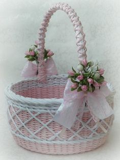 two wicker baskets decorated with pink flowers and bows