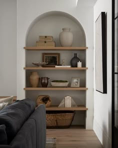 a living room filled with furniture and shelves