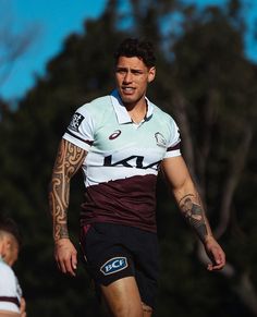 a rugby player with tattoos on his arm