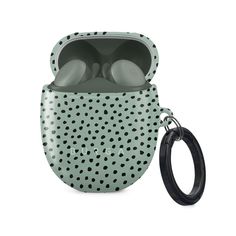 an airpods case with polka dots on it and a black rubber keychain