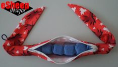 a red and white flowered mask with blue eyeshade hanging from it's side