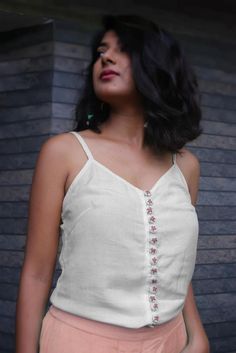 Linen top for women, White top, Linen tank top, Tops for summer, Made to order, Custom made, Plus sizeWear these linen tops with tight fitted jeans or loose bottoms.. these linen tops are meant to make you look more up to date with fashion with a touch of Indian folk embroidery.-Model height: 5'3" wearing size S-Top length: 22"-0.5" strap-Hand embroidered buttons-Closure: Front buttons**Note: Free Shipping time 15-21 days. Express Shipping time 5-7 days.** White Fitted Sleeveless Crop Top, Fitted Linen Tank Top For Spring, Casual Fitted Sleeveless Camisole, Fitted Sleeveless Casual Camisole, Fitted Casual Sleeveless Camisole, Fitted Linen Tops For Day Out, Fitted Crop Top Tank For Day Out, Summer V-neck Cotton Camisole, Fitted Cotton Camisole Tank Top