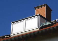 a chimney on top of a building with a blue sky in the background