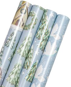 four rolls of wrapping paper with christmas trees and snowflakes on them, all rolled up