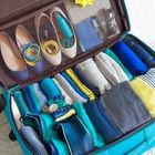 an open suitcase filled with lots of shoes