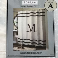 a shower curtain with the letter m on it