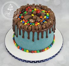 a birthday cake with chocolate and candy toppings