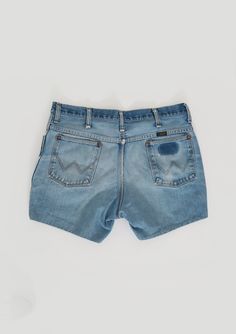 "Vintage 1970s Wrangler cut off shorts Medium light wash blue jeans with embroidered W back pockets and black label Wrangler 100% cotton Great vintage condition - burnout with perfectly worn in with stains (see photos) Cut off jeans have with sewn hem M e a s u r e m e n t s: Size: 36 30 - actual W35 Waist: 17 1/2\" Hips: 22\" Total length: 14 1/2\" Material: 100% cotton Inseam: 5\" Rise: 12\" Label: Wrangler - style 82612NV made in USA +All Measurements are taking while garment is lying flat+ i Vintage Cutoff Jean Shorts In Medium Wash, Vintage Medium Wash Cutoff Jean Shorts, Vintage Medium Wash Jean Shorts With Frayed Hem, Vintage Distressed Jean Shorts, Vintage Distressed Medium Wash Shorts, Vintage Faded Cotton Shorts, Retro Light Wash Short Jeans, Vintage Distressed Cutoff Jean Shorts, Vintage Cutoff Faded Shorts