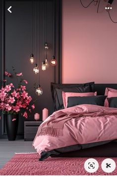 a pink and black bedroom with flowers in vases on the floor, chandelier hanging from the ceiling