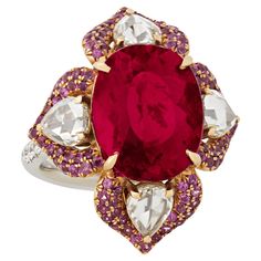 The gems of this visually striking ring come together to form a deep red floral motif. The large central rubellite tourmaline totals 9.41 carats, and displays its coveted vibrant and rich red hue. Accented by 1.37 carats of pink garnets and 0.21 carats of diamonds, the jewels shine in their 18K gold settings. Cocktail Party Jewelry, Rubellite Ring, Pink Garnet, Heritage Jewellery, Silver Cocktail, Rubellite Tourmaline, Historical Jewellery, Floral Ring, Party Jewelry