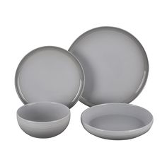 three white plates and two bowls on a white background