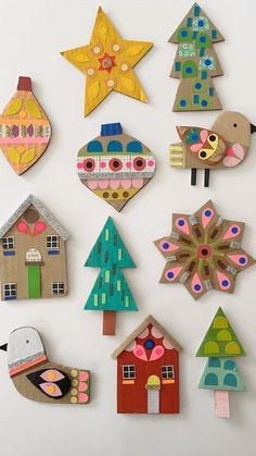 a group of wooden cut outs with different designs and shapes on them, all decorated in various colors