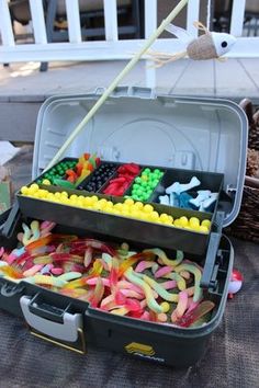 an open suitcase filled with lots of different colored candies and candy sticks in it