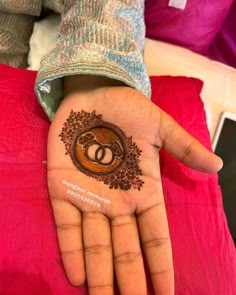 a woman's hand with a henna on it and the word love is written in