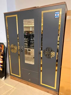 a large gray and gold cabinet in a store