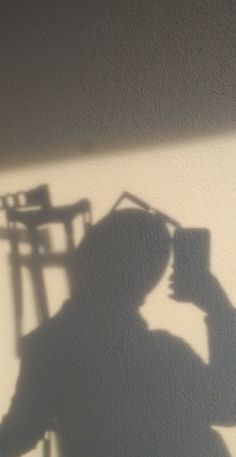 the shadow of a person sitting in a chair