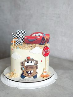 a birthday cake with cars on it and a stop sign