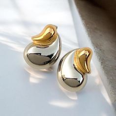 These stunners are the perfect blend of sleek and chic, adding just the right touch of glam to any outfit.  The Duadrop statement earrings are stylish and totally eye-catching. These 18k gold plated stainless steel beauties are tarnish free and waterproof. All of our jewelry comes in a beautiful 100% cotton pouch. It makes the perfect gift! Gold And Silver Earrings, Statement Earrings Gold, Cotton Pouch, Teardrop Earrings, Earrings Gold, Gold And Silver, Statement Earrings, Halloween Shopping, Favorite Jewelry