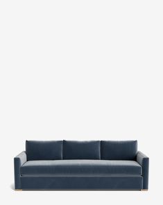 a blue couch against a white wall