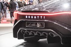 the rear end of a car on display at an auto show