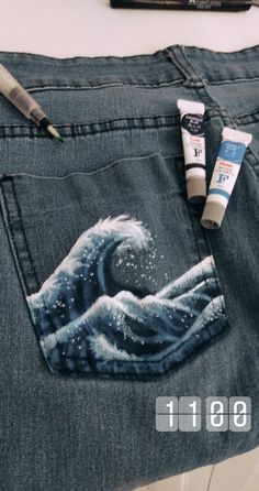 a pair of blue jeans with some paint and toothpaste in the back pocket