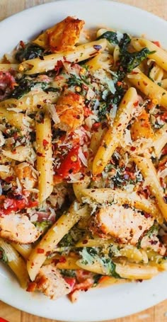 a white plate topped with pasta and chicken