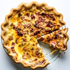 a quiche on a plate with one slice missing