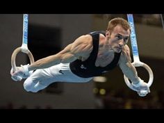 a man is doing tricks on the rings