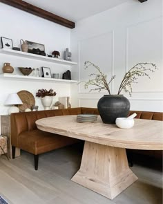 a large wooden table sitting in the middle of a living room