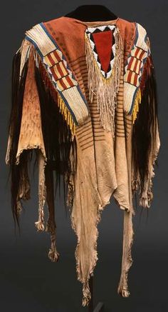 an old native american blanket with fringes on it's shoulders and back ends