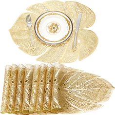 a set of four place settings with gold leaf design