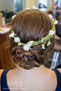 a woman with flowers in her hair is wearing a flower headpiece on her wedding day