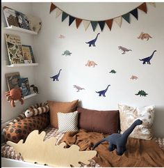 a bedroom with dinosaur decals on the wall