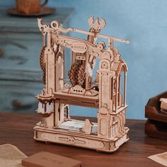 a wooden model of a mechanical device on a table