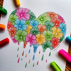 a heart shaped drawing with flowers and raindrops painted on the paper next to crayons