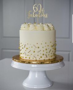 a white cake with gold sprinkles on top