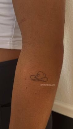 a woman's arm with a small tattoo on the left side of her leg