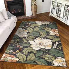 a living room filled with furniture and a rug on top of a hard wood floor