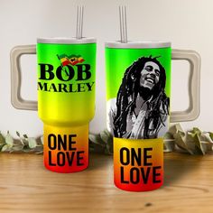 two bob marley coffee mugs sitting next to each other