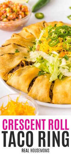 an easy taco crescent roll ring with shredded cheese, lettuce and other toppings