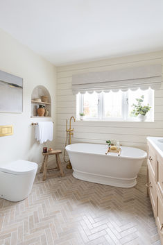 Dijon tumbled metro tiles laid in a herringbone pattern, in a newly renovated bathroom.