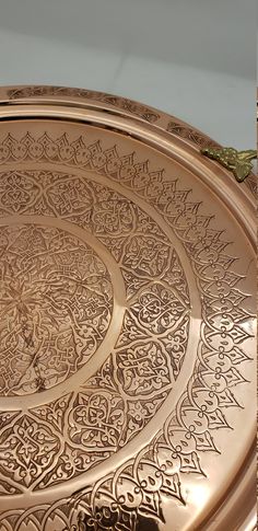 an intricately designed metal tray on display