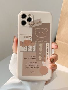 a person holding up a phone case with a bear design on the front and bottom