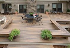 a wooden deck with benches and tables on it