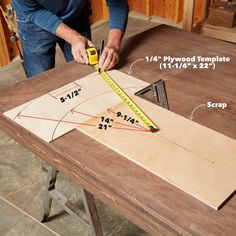 a man measuring the width of a piece of wood with a tape measure on it