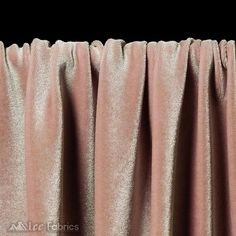 a close up view of a pink curtain