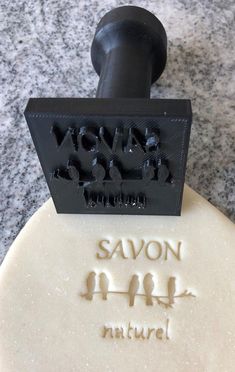 a soap bar with the words savon and nature carved into it on a marble surface