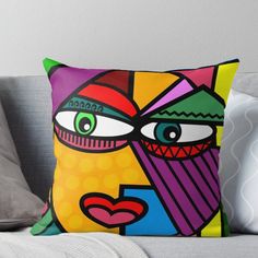 the face of a woman with green eyes and colorful shapes on it's face throw pillow