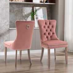 two pink chairs sitting next to each other